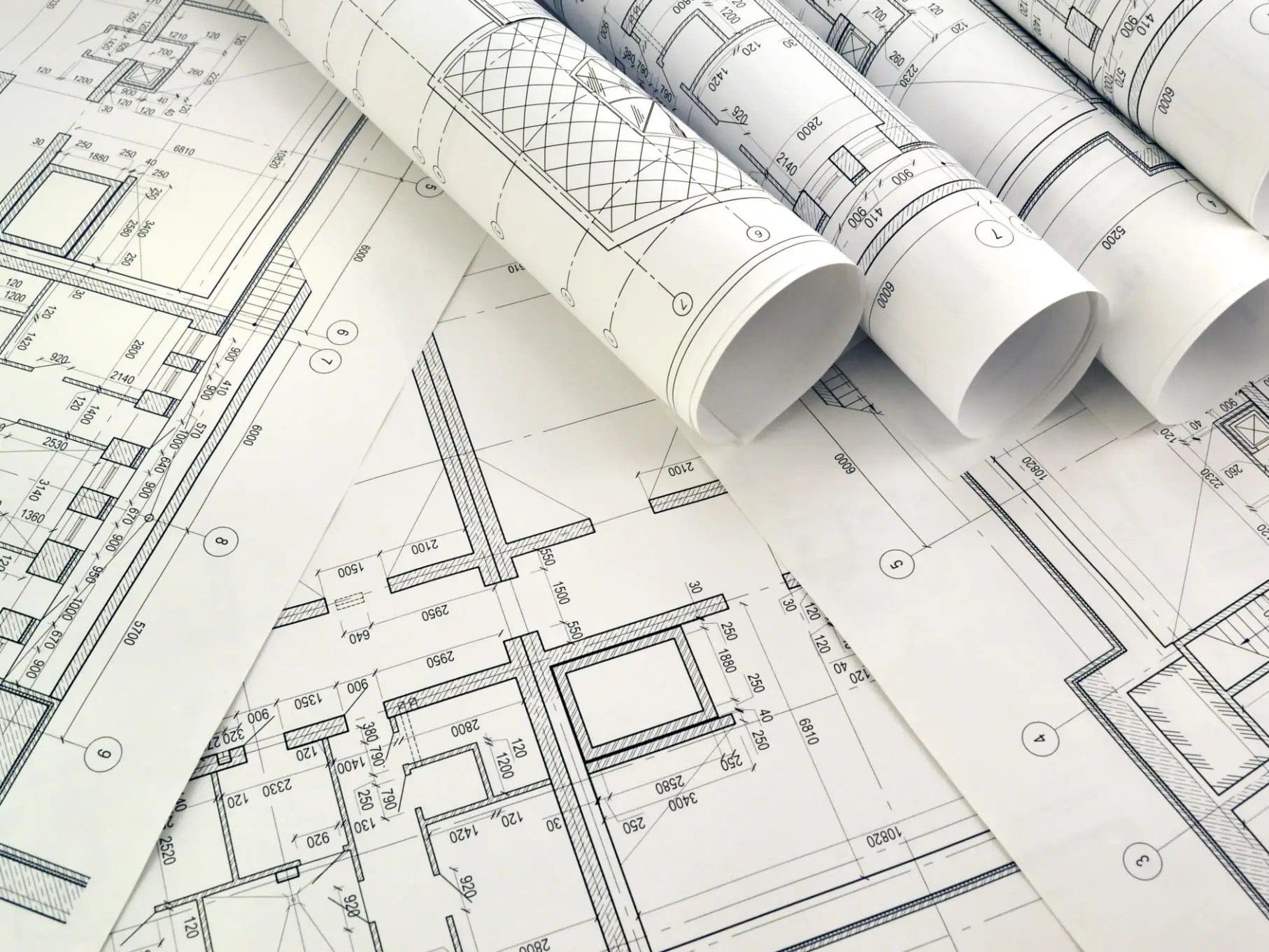 Architectural blueprints and rolled design plans.