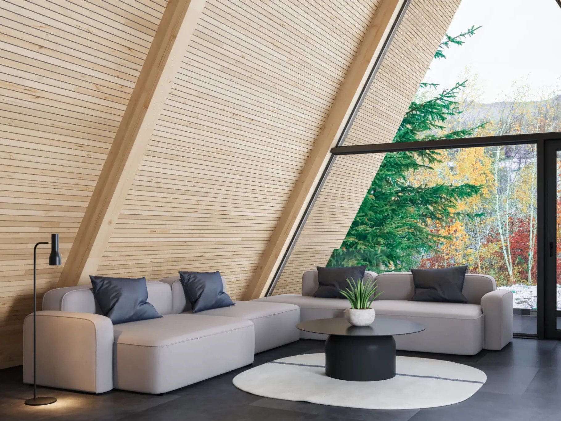 Modern A-frame living room with large windows.