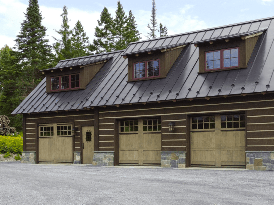 Rustic garage with three wooden doors.