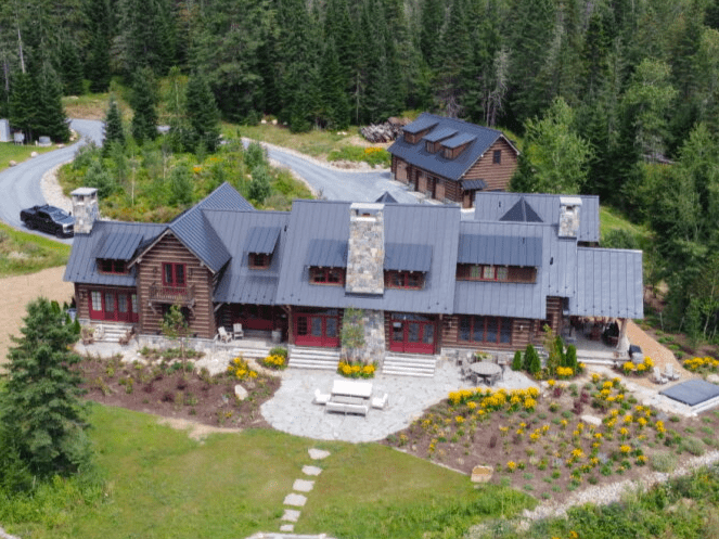 Aerial view of large rustic house.